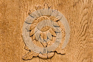 Wooden background with a relief of a beautiful sunflower