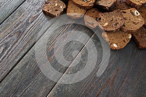Wooden background with rye bread slices, copyspace