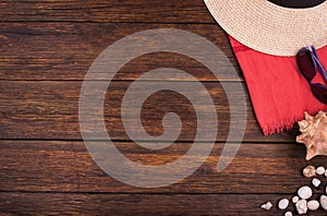 Wooden background with shells, sunglasses, hat