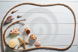 Wooden background with starfish, sea shells and marine rope