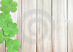 Wooden Background Texture with Green Shamrocks clover leaf at left side for St. Patrick`s Day