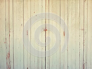 Wooden background. Texture with an old, ywllow, green and brown door.