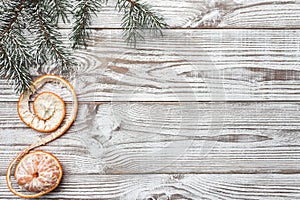 Wooden background. White. Winter card. Green fir branches. Tangerine. Xmas card. Space for Christmas or New Year`s greeting messa photo