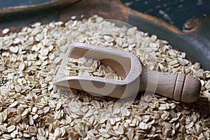 Wooden bailer with oat flakes photo