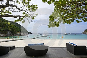 Wooden balcony and living room set by the sea. Relaxing chair set with beach and harbor views in the island of Phuket, Thailand.