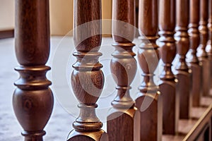 Wooden balustrade of classic staircase in modern house. Close-up