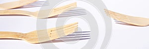 Wooden bamboo cutlery forks on bright white background