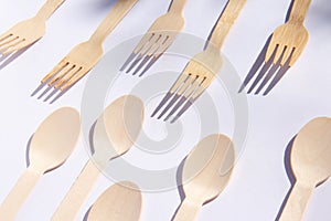 Wooden bamboo cutlery spoons and forks on bright white background