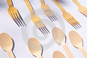 Wooden bamboo cutlery spoons and forks on bright white background