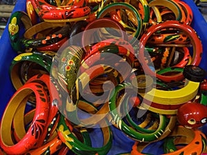 Wooden bangles in a blue  tray, Colourful wooden decorative jewellery.