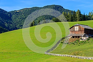 Wooden barn on hill in Dolomites Mountains, Italy