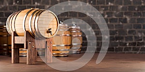 Wooden barrel with faucet mounted horizontally on dark old stone wall background in cellar with wooden barrels. copy space. 3d