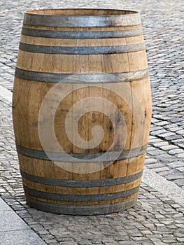 Wooden barrel on paving stones