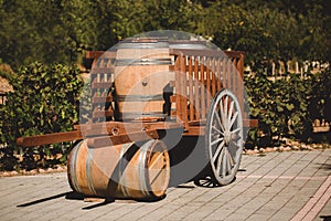 Wooden barrel with red and wihte wine for tasting in cart on the vineyard. Textured object