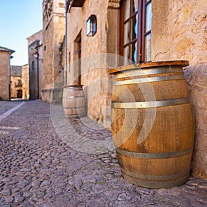 Wooden barrel to store wine in the narrow streets of the medieval village of Pedraza, Segovia.