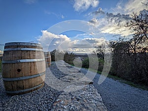 Wooden barrels captured with the cloudy sky
