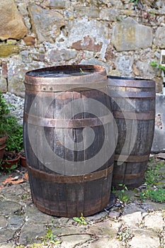 Wooden barrels in garden on stones wall