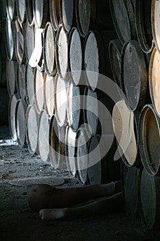 wooden barrels stacked in old abandoned industry building