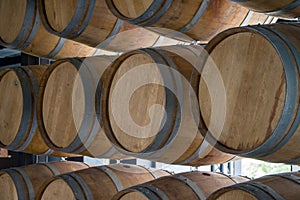 Wooden barrels stand on top of each other, wine storage, part of the interior, the structure of the tree.