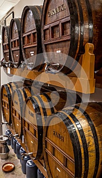 Wooden barrels with taps and with Garnacha, black, white, muscatell photo