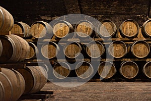 Wooden barrels for wine aging in the cellar..Italian wine