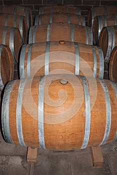 Wooden barrels for wine storage in a cellar photo
