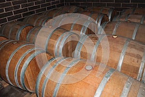 Wooden barrels for wine storage in a cellar photo