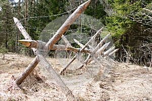 Wooden barricade with a barbed wire