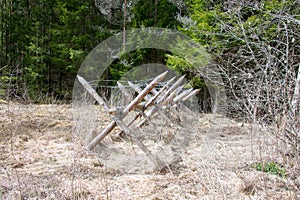 Wooden barricade with a barbed wire