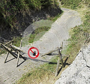 Wooden barricade with barbed wire fence in nature