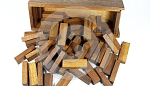 Wooden bars for a board game in a tower puzzle Jenga. Chaotic scattered on a white background