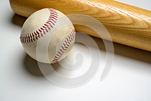 A wooden baseball bat and leather ball on white background