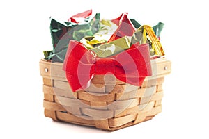 A Wooden Basked Filled with Foil Wrapped Chocolate Truffles Isolated on a White Background