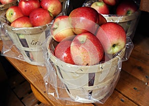 Wooden basket of vibrant red apples