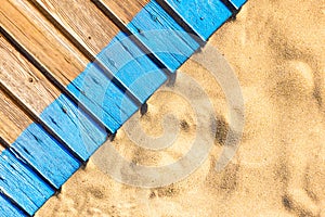 Wooden beach boardwalk with sand for texture or background