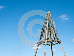 Wooden beacon called Baken or Kaap against blue sky on island Schiermonnikoog, Netherlands