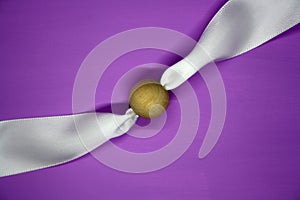 Wooden bead on a purple background. Craft
