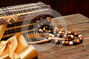 Wooden beads, wooden casket and hairbrush on table