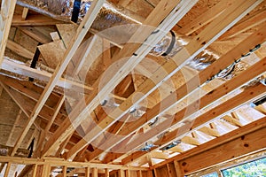 Wooden beamed ceiling in new home gains prominence with installation of a central HVAC system.