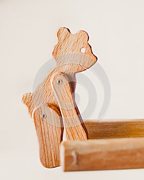 A wooden bear cub lifts the boards with its front paws. Ecological interactive wooden toy, i
