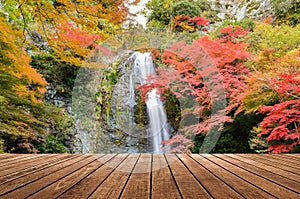 Wooden on beautiful waterfall in autumn background