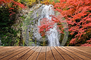 Wooden on beautiful waterfall in autumn background