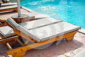 Wooden bed beside the pool