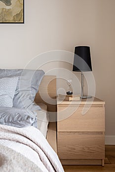 Wooden bedside table with drawers