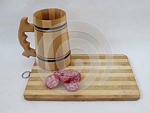 Wooden beer mug and salami