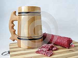 Wooden beer mug and salami