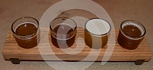 Wooden beer sampling tray with four brews