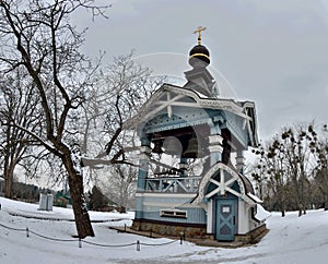 Wooden Belfry of Holy Trinity monastery of Saint Jonah with beautiful carving, located in botanical garden of Hryshko,Kiev Ukraine