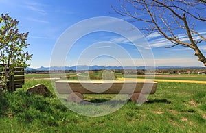 Wooden Bench in the Bavarian Chiemgau with view to the Alps