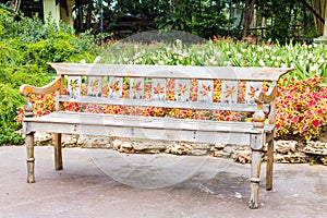 Wooden bench in beautiful garden background